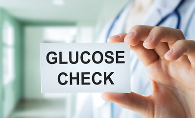 Doctor hands holding white card sign with glucose check text message