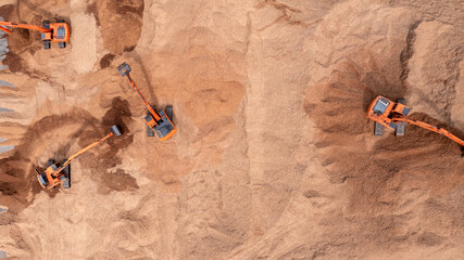 Aerial view road motor grader flatting dirt road surface, Motor grader road construction grader industrial machine construction site new road, Aerial view group excavator working on construction site.