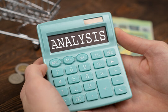 Text Analysis lying on the calculator in hand. Magnifying glass with green pen on financial documents