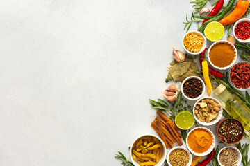 An array of culinary herbs and spices arranged on a gray background, adding aromatic accents...