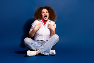 Full length photo of impressed positive woman wear white shirt looking empty space isolated blue color background