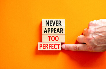 Never appear too perfect symbol. Concept words Never appear too perfect on beautiful wooden blocks. Beautiful orange table orange background. Business and never appear too perfect concept. Copy space.