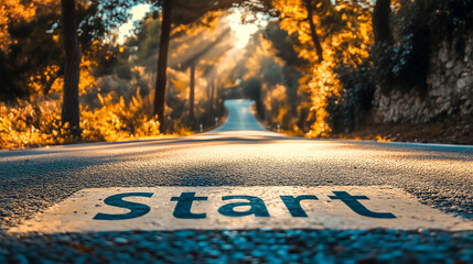 "Start" written on asphalt road with sunflare and beautiful nature scene .