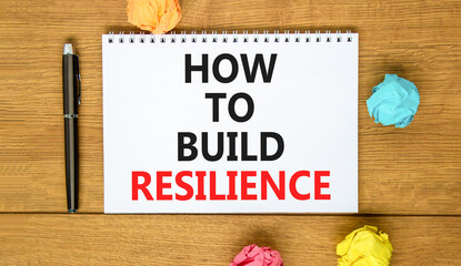 Fototapeta premium How to build resilience symbol. Concept words How to build resilience on beautiful white note. Beautiful wooden background. Black pen. Business and how to build resilience concept. Copy space.