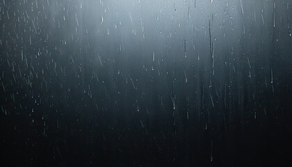Raindrops on a dark background, ideal for weather and nature-related themes.

