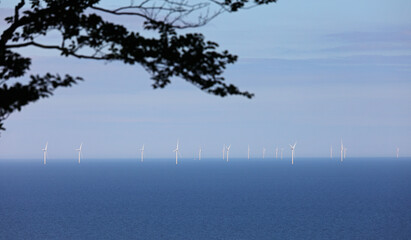 offshore wind farm in the middle of the sea with turbines generating sustainable electricity