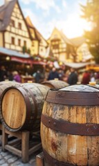 Fototapeta premium Wooden barrels displayed at a European Christmas market, with blurred background of festive atmosphere.