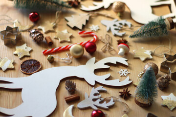 Various Christmas decorations in neutral colors on wooden background. Selective focus.