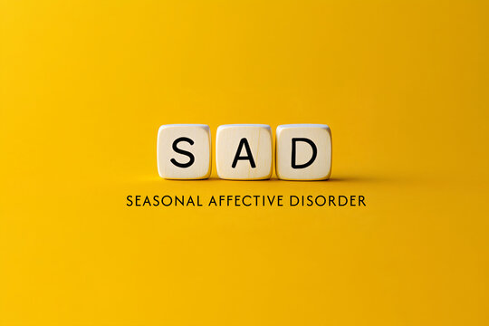 3d cubes with letter SAD on yellow background. Concept template with text "seasonal affective disorder", awareness month and help for people with mental problems