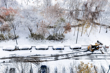 aerial view of the first snow covered parked cars