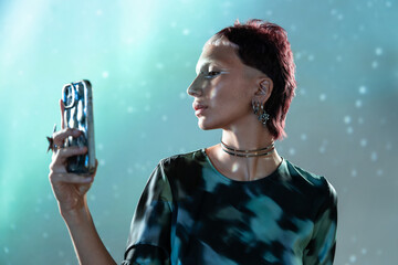 Futuristic woman with holographic smartphone in the metaverse