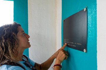 Woman Interacts with Braille Sign on a Routine Day