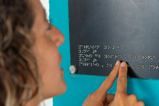 Woman Reading Braille, Navigating Deaf-Blind Challenges Daily