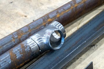 Junction several pipes. Components for creating complex pipeline. Fragment of pipe with connection to water supply network. Pipeline branch. Rusty pipes with polished edges. Pipes for utilities