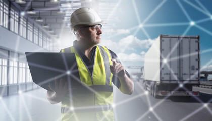 Man logistician controls transportation on truck. Logistics company dispatcher holding laptop....