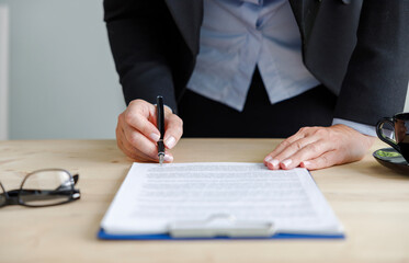 Businesswoman signing an official document