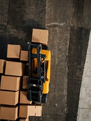 Aerial view of stacked cardboard boxes beside a forklift.