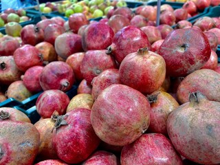 fresh farm organic pomegranates in a box for sale in a store