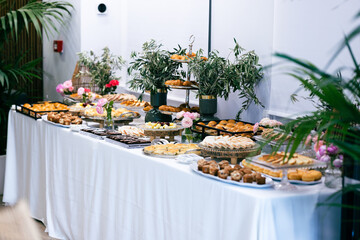 A buffet table full of unhealthy food decorated for a celebration
