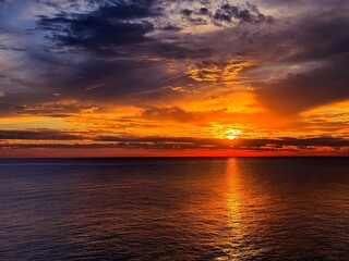 Night sunset sky over ocean dark water. 