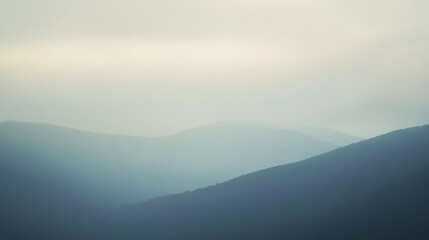 Obraz premium A serene and atmospheric landscape featuring soft gradients of misty gray, pale blue, and lavender hues. The subtle textures and diffused light create a calm and mysterious ambiance