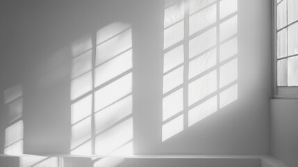 Obraz premium Monochrome abstract background with shadows and light from window on white wall