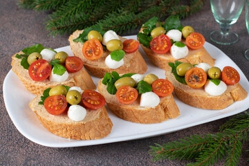 Bruschetta with tuna pate, mozzarella, olives and cherry tomatoes