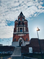 A beautiful building standing tall against a vibrant sky, its architecture contrasting with the dynamic clouds above. The perfect blend of man-made beauty and natural wonder.A beautiful building stand