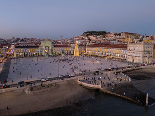 Illuminated Lisbon City at Evening Twilight on Christmas Holiday. Commerce Plaza and Christmas Tree. Portugal. Aerial Drone Shot