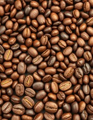 Naklejka premium Close-up view of various roasted coffee beans showcasing rich textures and colors in a natural setting