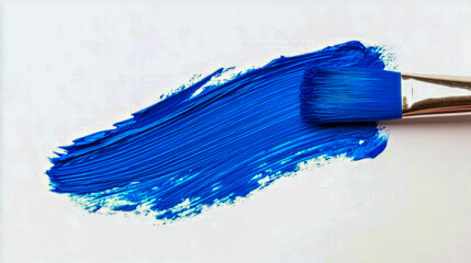 Vibrant blue paint stroke with brush on white background