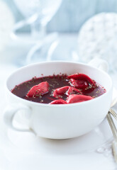 Traditional Christmas Borscht (Barszcz) with mushroom dumplings on bright background.