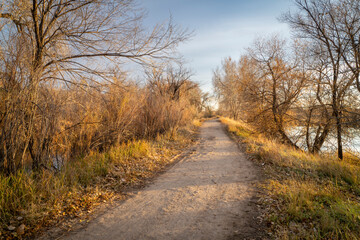 gravel hiking and biking trail in late fall scenery in one of natural areas in Fort Collin, Colorado