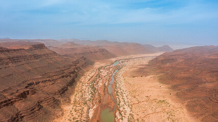 Moroccan Sahara Desert, ancient black volcanic mountains, the Sahara River Oued Ghris, stunning...