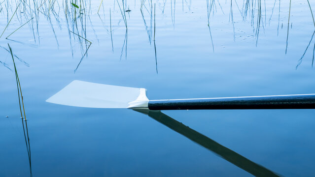 hatchet sculling oar on a calm lake, Boyd Lake in Colorado