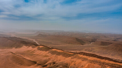 Naklejka premium Moroccan Sahara Desert, ancient black volcanic mountains, the Sahara River Oued Ghris, stunning Acacia trees, wild camels, and desert camp, landscape where golden sand dunes merge with green plants