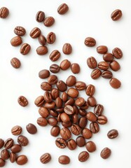 Coffee beans scattered on a white background showcasing their rich brown color and distinct textures during a sunny morning