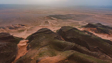 Moroccan Sahara Desert, ancient black volcanic mountains, the Sahara River Oued Ghris, stunning...