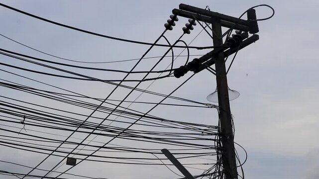 Power pole cable and gray sky on Phuket island Thailand.