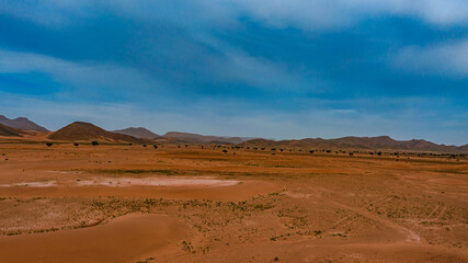 Moroccan Sahara Desert, ancient black volcanic mountains, the Sahara River Oued Ghris, stunning...