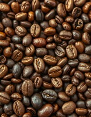 Freshly roasted coffee beans spread across the surface showcasing various shades of brown and rich textures