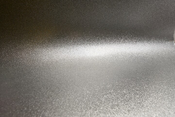 Shiny Silver Glitter Texture with Light Gradient. A sparkling silver glitter texture featuring a soft gradient and metallic shine, ideal for elegant backgrounds and creative projects.

