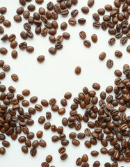 Coffee beans scattered on a white surface create a rich texture and inviting aroma for coffee enthusiasts exploring flavors