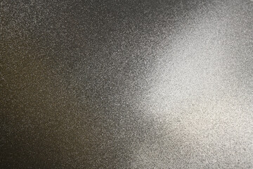 A sparkling silver glitter texture featuring a soft gradient and metallic shine, ideal for elegant backgrounds and creative projects.
