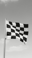 Fototapeta premium Checkered flag waving against a clear sky during a motorsport event