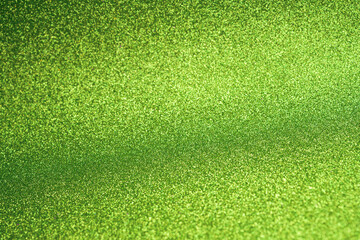 Vibrant Green Glitter Texture Background. Bright and sparkling green glitter texture with a soft...