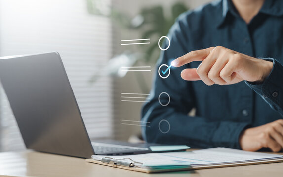 check, document, checklist, choice, guarantee, answer, assurance, certificate, choose, list. A person is pointing at check mark list. The person appears to be checking something on the document.