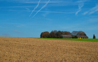 Fototapeta premium A small farm house with fields in front of it.