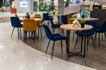Coffee shop in the mall. Empty tables. Empty food court interior