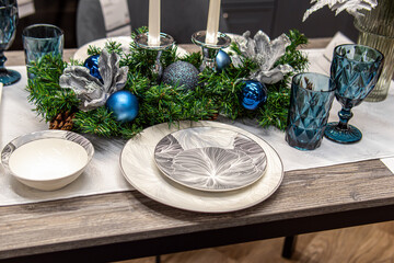 Christmas composition on the table with candles, fir branches and Christmas balls